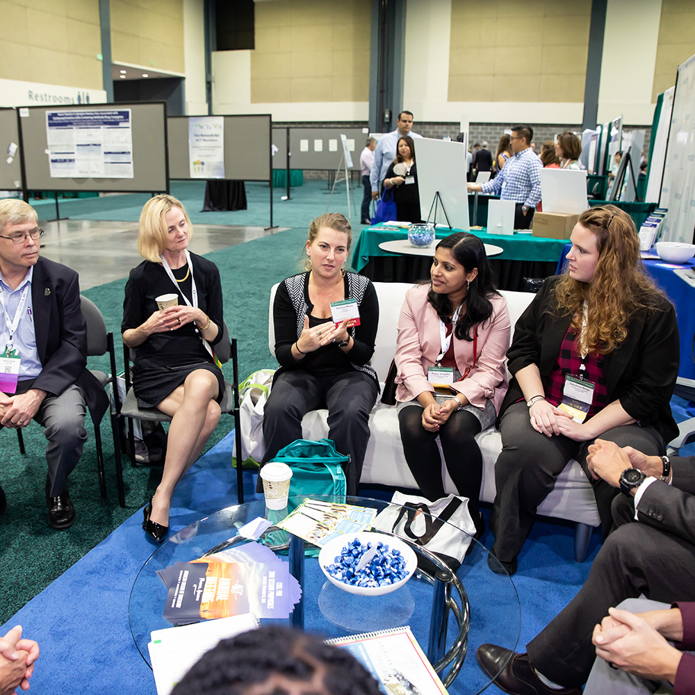 Attendees chatting in the ACT Lounge