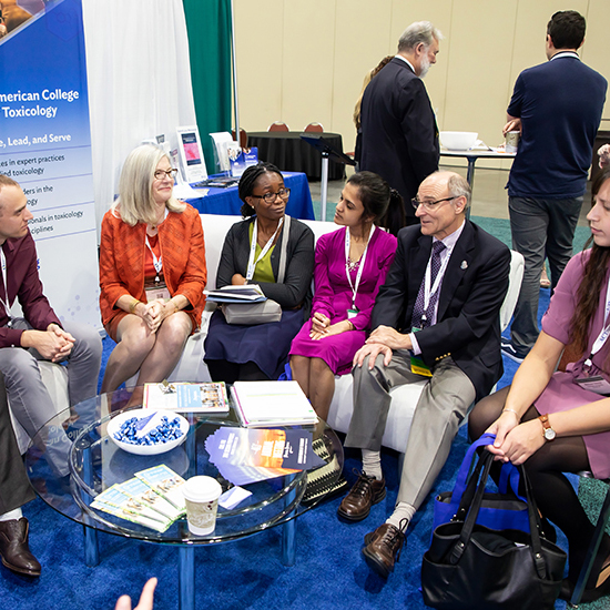 Attendees chatting in the ACT Lounge