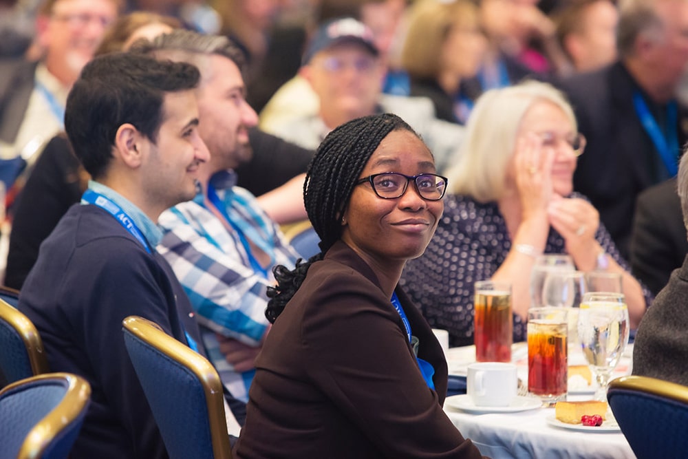 Attendee smiling at the camera